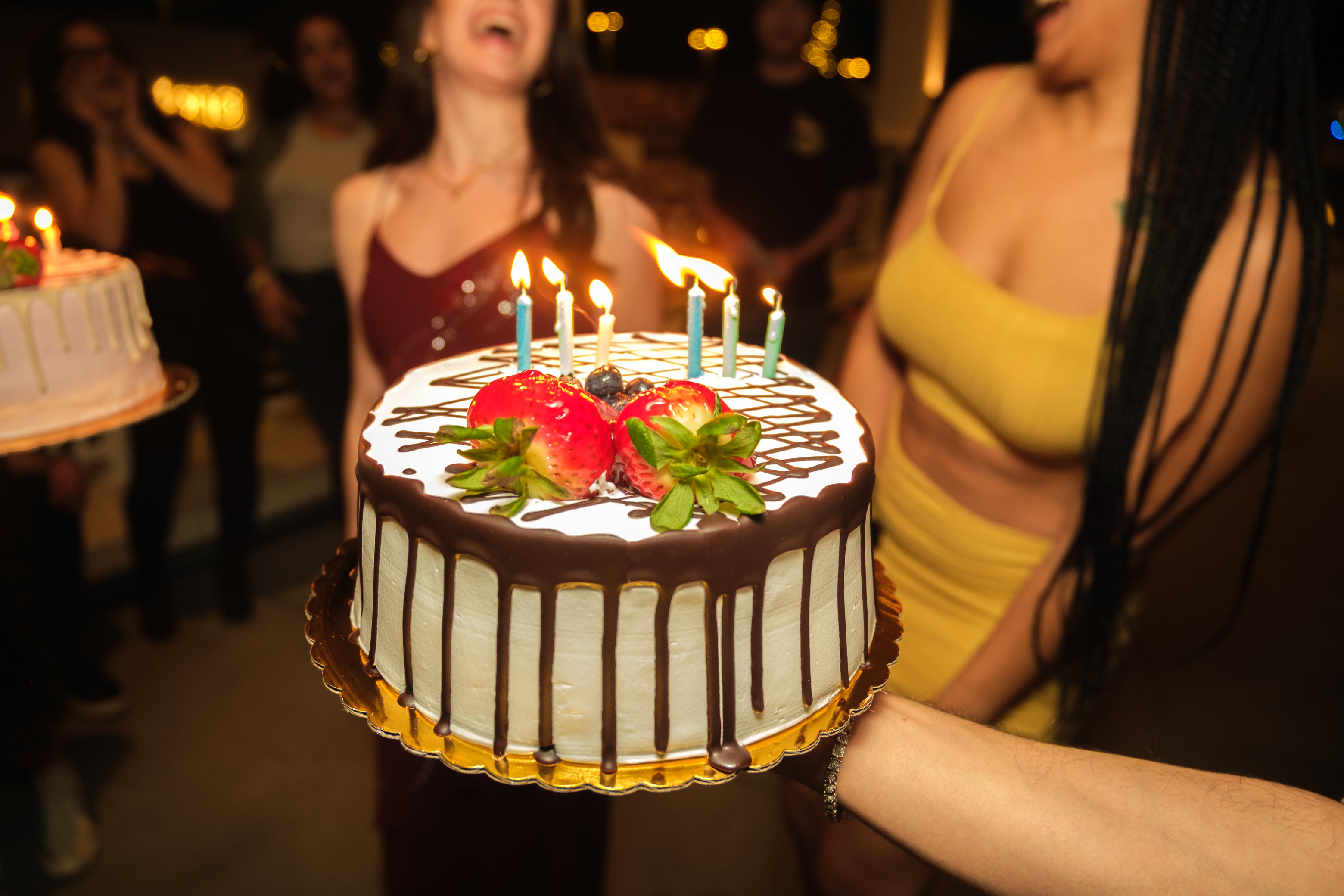 A cake being offered to two ladies